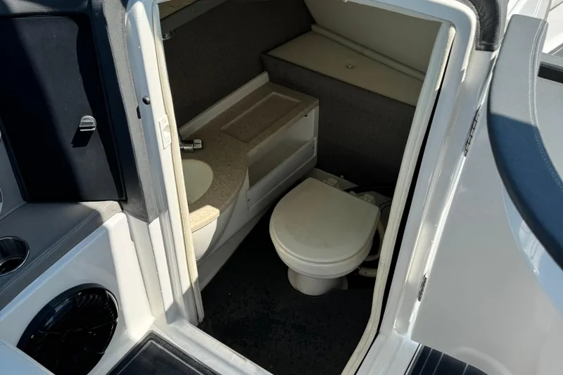 Slide: The Image of 2013 Cobalt 26SD WSS boat interior with compact bathroom and sink. - 9