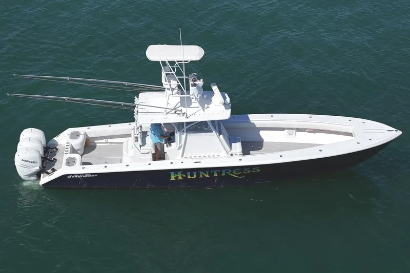 Slide: The Image of 2007 SeaHunter 40 boat named "Huntress" on water, aerial view. - 1