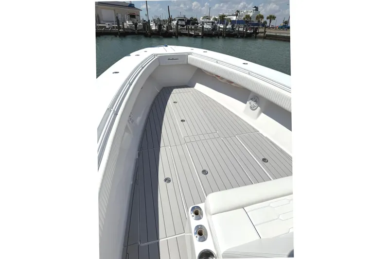 Slide: The Image of 2007 SeaHunter 40 boat deck with sleek design, docked at marina under clear sky. - 10