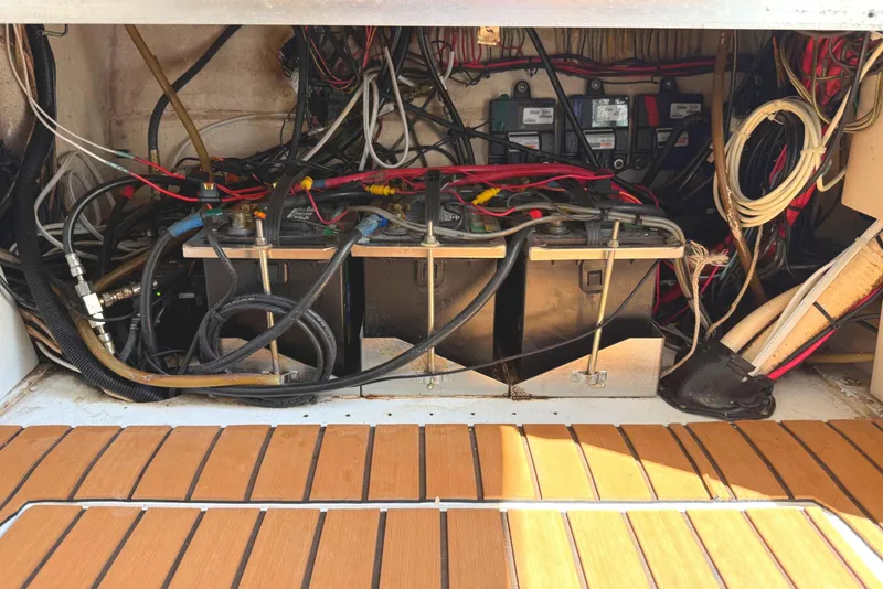 Slide: The Image of Electrical wiring and batteries in a 2007 SeaHunter 40 boat compartment. - 11