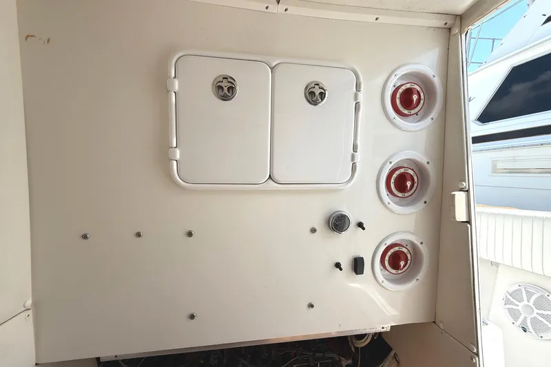 Slide: The Image of Control panel on a 2007 SeaHunter 40 boat with switches and storage compartments. - 14