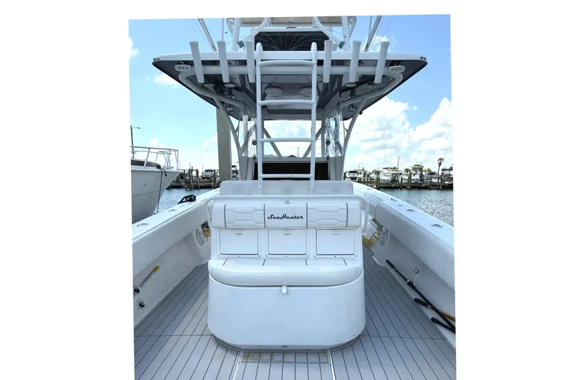 Slide: The Image of 2007 SeaHunter 40 boat interior with seating and rod holders, docked at marina. - 18