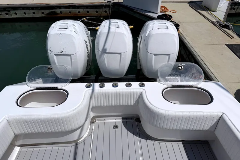 Slide: The Image of 2007 SeaHunter 40 boat with triple outboard engines at dock. - 20