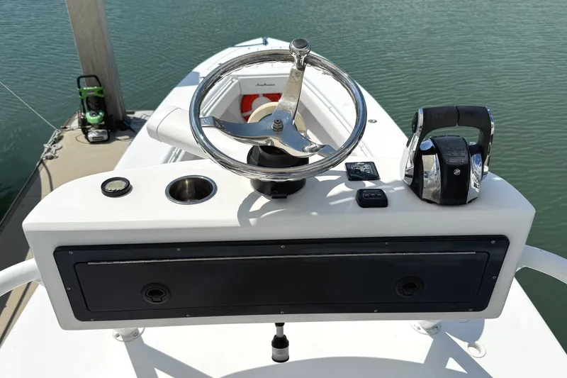 Slide: The Image of Steering console of a 2007 SeaHunter 40 boat, featuring a chrome wheel and controls. - 27