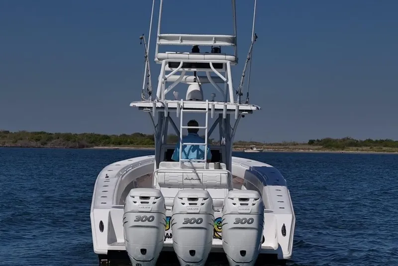 Slide: The Image of 2007 SeaHunter 40 boat with triple 300 horsepower engines on open water. - 7