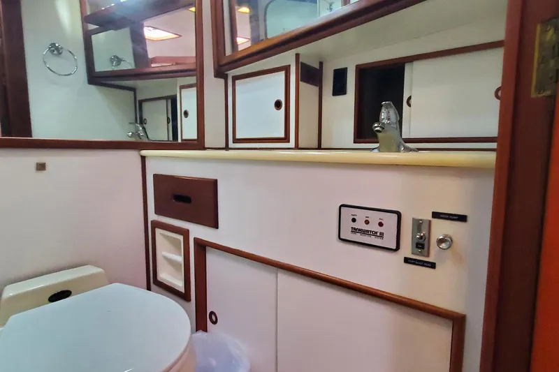 Slide: The Image of Bathroom interior of 1997 Grand Banks 46 Europa yacht, featuring sink and storage cabinets. - 13