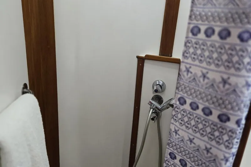 Slide: The Image of Shower area in 1997 Grand Banks 46 Europa yacht with patterned curtain and towel. - 14