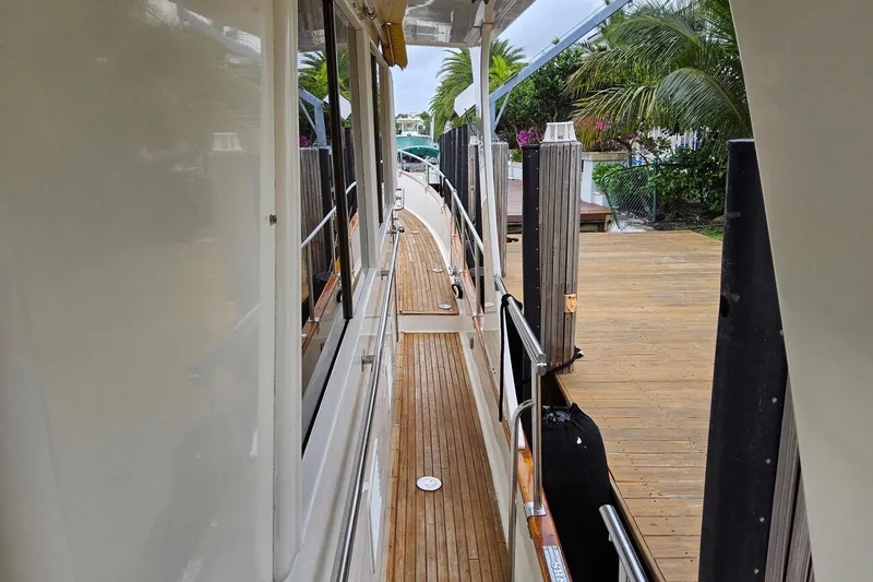 Slide: The Image of Side deck of a 1997 Grand Banks 46 Europa yacht, docked with wooden walkway. - 16