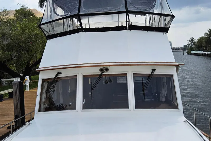 Slide: The Image of 1997 Grand Banks 46 Europa yacht docked by a serene waterfront. - 17