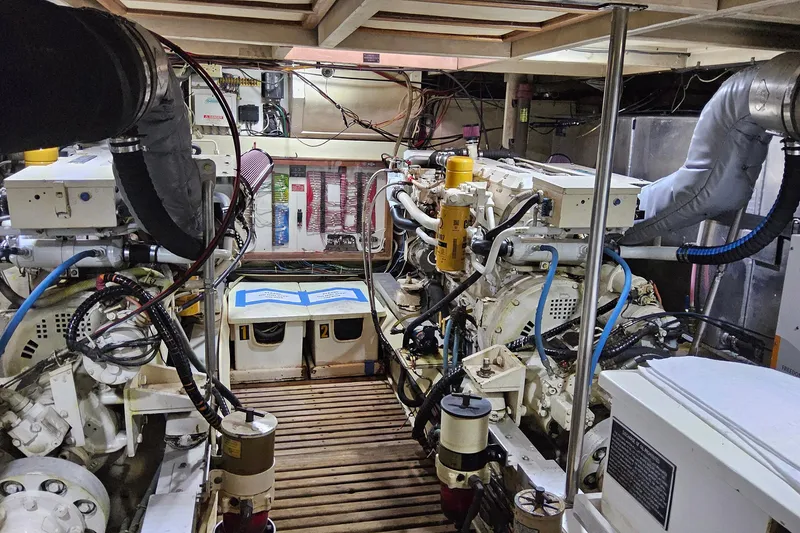 Slide: The Image of Engine room of a 1997 Grand Banks 46 Europa yacht, showcasing machinery and equipment. - 19