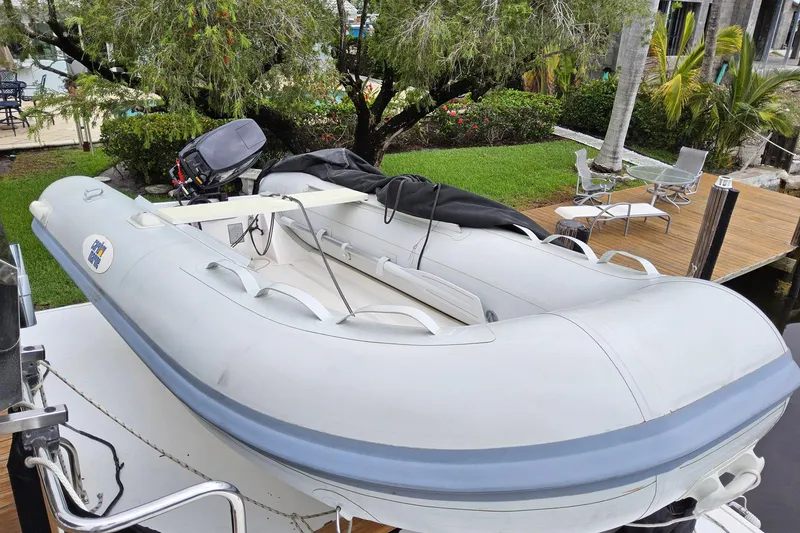 Slide: The Image of Inflatable boat on Grand Banks 46 Europa, 1997, docked near lush garden and patio. - 25