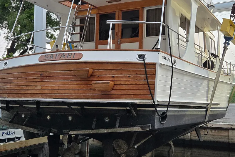 Slide: The Image of Grand Banks 46 Europa 1997 yacht "Safari" on dry dock, showcasing wooden and white exterior. - 28