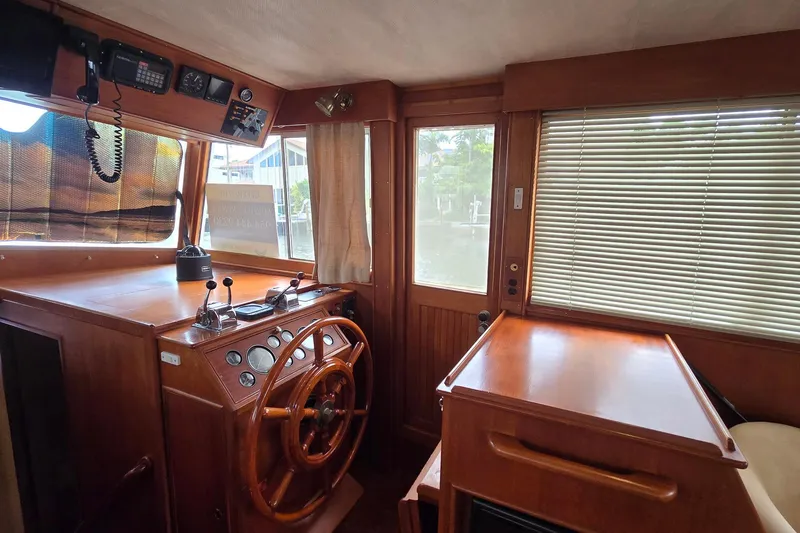Slide: The Image of Interior helm of 1997 Grand Banks 46 Europa yacht with wooden steering wheel and controls. - 8