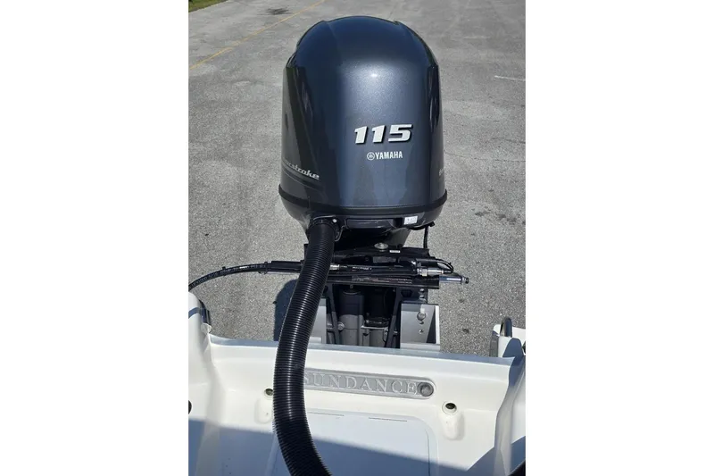 Slide: The Image of 2026 Sundance B22CCR boat with Yamaha 115 outboard motor on a sunny day. - 5