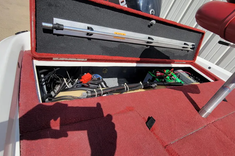 Slide: The Image of Open storage compartment in 2000 Nitro 640LX boat, showing wiring and equipment. - 10