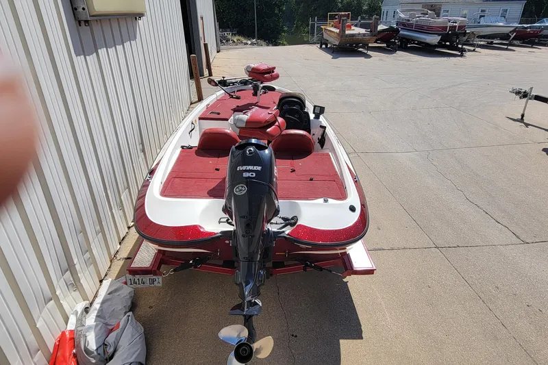 Slide: The Image of 2000 Nitro 640LX boat with Evinrude 90 engine, parked outdoors on concrete. - 13