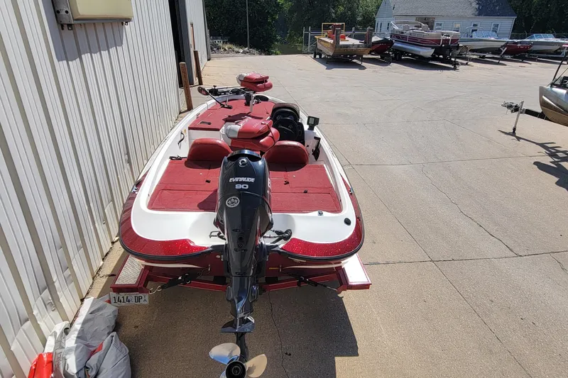 Slide: The Image of 2000 Nitro 640LX boat with Evinrude 90 engine, parked outdoors. - 14
