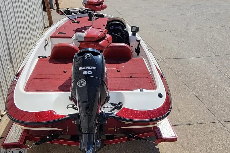 Slide: The Image of Red and white 2000 Nitro 640LX boat with Evinrude 90 engine on trailer. - 17