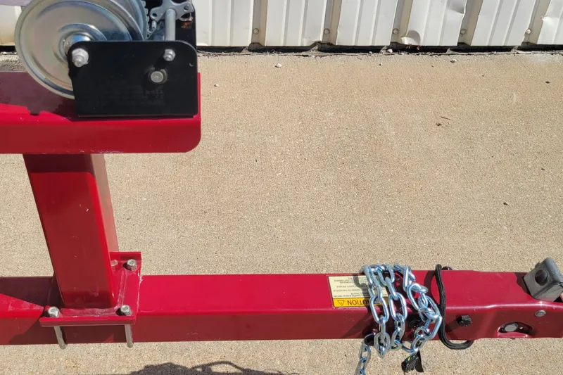 Slide: The Image of Red Nitro 640LX trailer hitch with chains, 2000 model, on concrete surface. - 24
