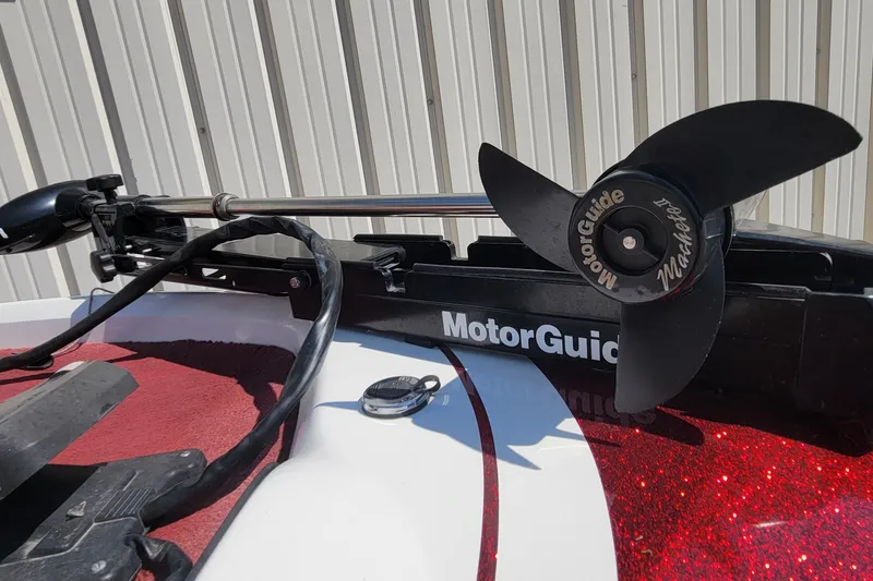 Slide: The Image of MotorGuide trolling motor on 2000 Nitro 640LX boat, red and white deck. - 25