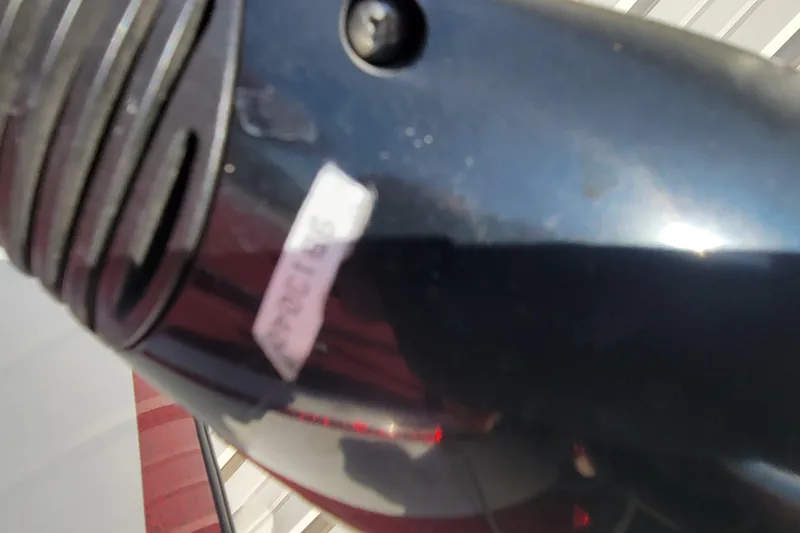 Slide: The Image of Close-up of a 2000 Nitro 640LX boat component with a sticker and screw detail. - 26