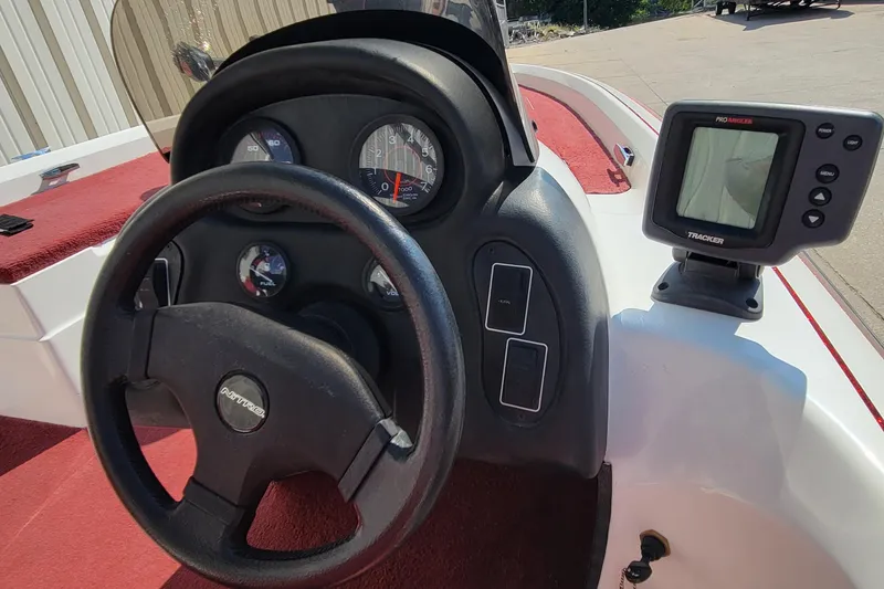 Slide: The Image of Steering wheel and dashboard of a 2000 Nitro 640LX boat with gauges and fish finder. - 30