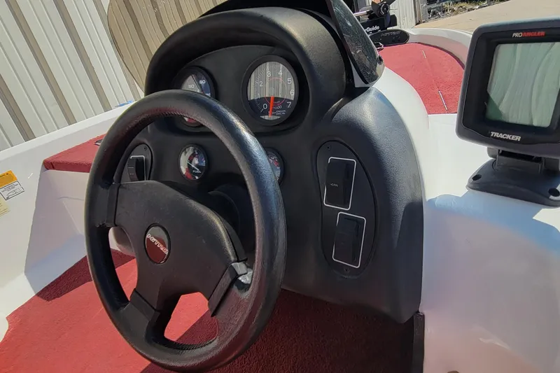 Slide: The Image of Steering wheel and dashboard of a 2000 Nitro 640LX boat with gauges and controls. - 31