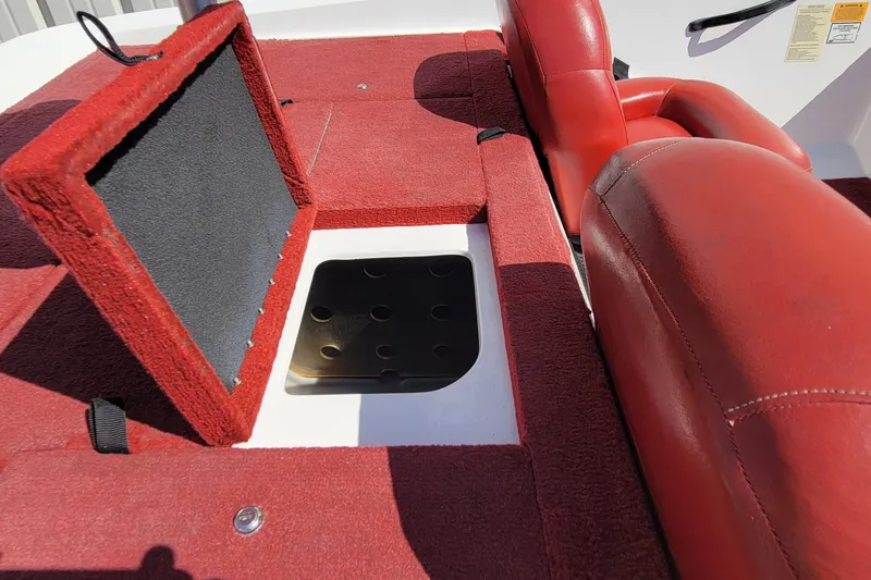 Slide: The Image of Red interior of 2000 Nitro 640LX boat with open storage compartment. - 34