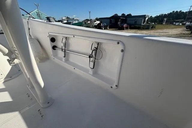 Slide: The Image of 2008 Clearwater 180 center console boat interior with rod holders and storage compartment. - 20