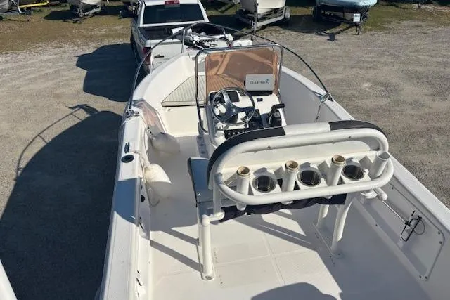 Slide: The Image of 2008 Clearwater 180 center console boat with steering wheel and rod holders, parked on gravel. - 19