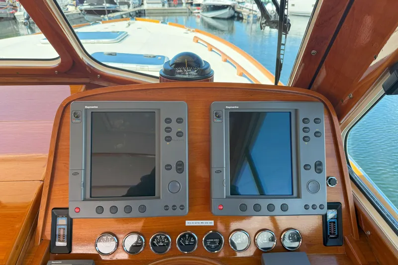 Slide: The Image of Hinckley Talaria 40 yacht dashboard with navigation screens and controls, 2003 model. - 12