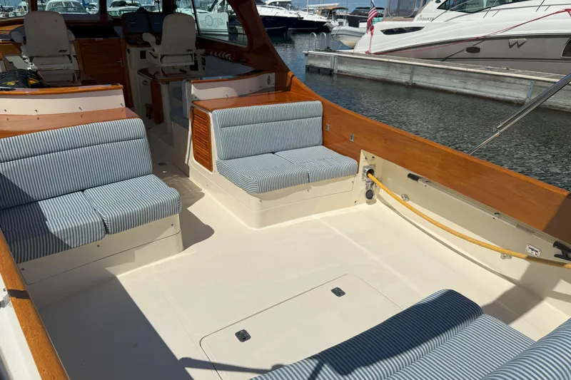 Slide: The Image of 2003 Hinckley Talaria 40 yacht interior with striped seating, docked at marina. - 2