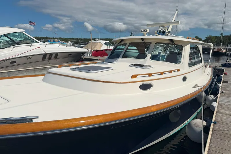 Slide: The Image of 2003 Hinckley Talaria 40 yacht docked at marina under cloudy sky. - 20