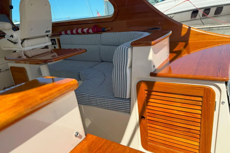 Slide: The Image of Interior of 2003 Hinckley Talaria 40 yacht with striped seating and polished wood finish. - 5