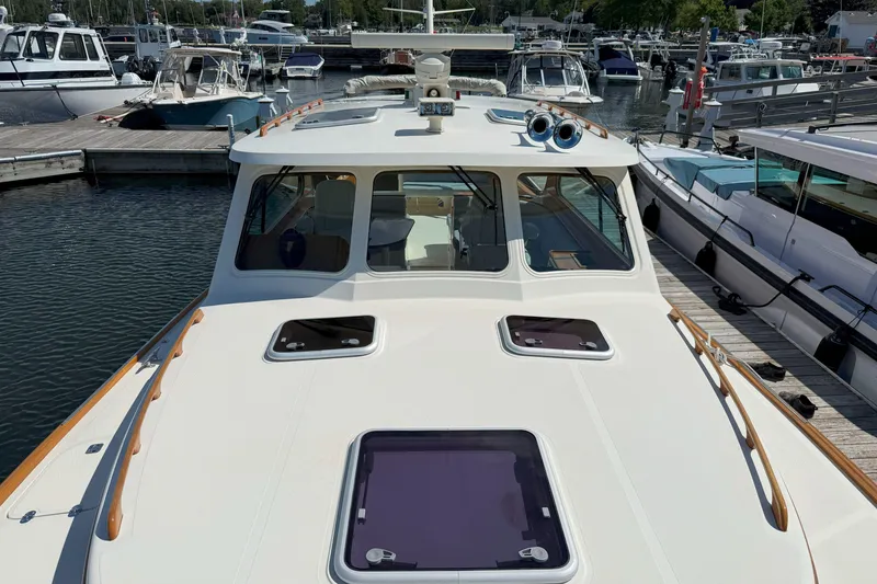 Slide: The Image of 2003 Hinckley Talaria 40 yacht docked at a marina, showcasing sleek design and craftsmanship. - 18