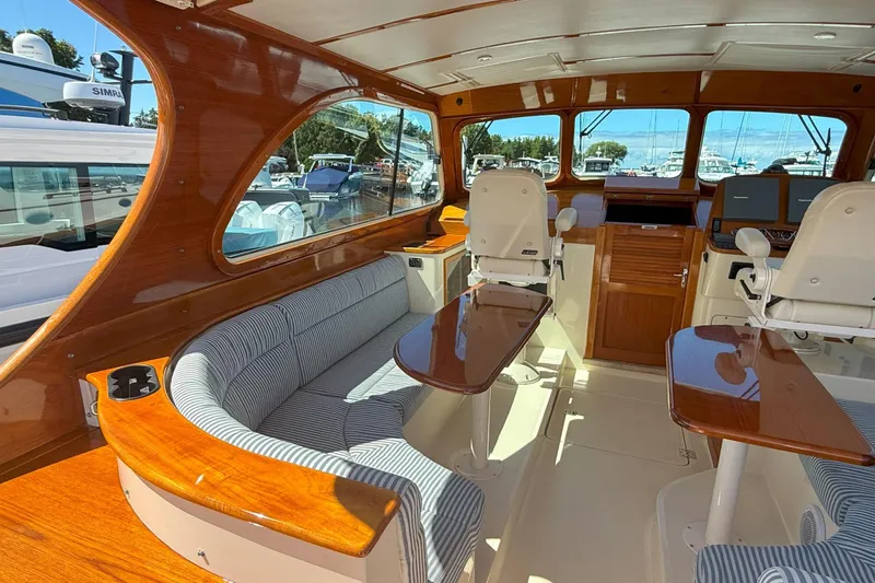 Slide: The Image of Luxurious interior of 2003 Hinckley Talaria 40 yacht with polished wood and striped seating. - 4