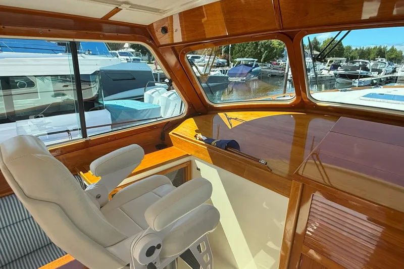 Slide: The Image of Interior of 2003 Hinckley Talaria 40 yacht with wooden finish and white captain's chair. - 8