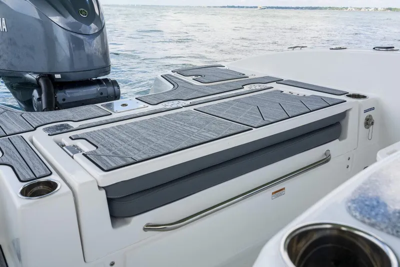 Slide: The Image of 2026 NauticStar 251 Hybrid boat with sleek deck design and powerful engine on water. - 10