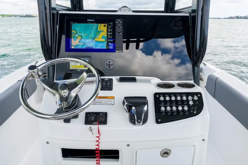 Slide: The Image of 2026 NauticStar 251 Hybrid boat dashboard with navigation system and controls. - 13