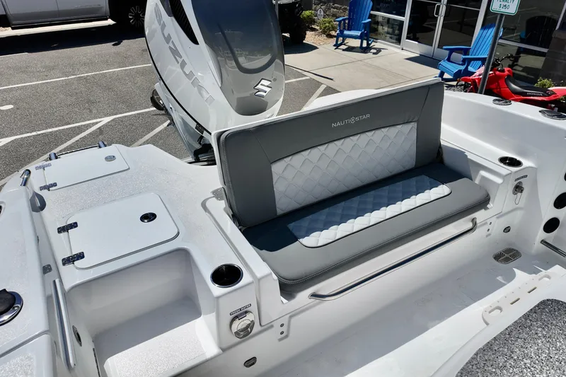 Slide: The Image of 2026 NauticStar 251 Hybrid boat interior with Suzuki engine, featuring stylish seating and storage compartments. - 16