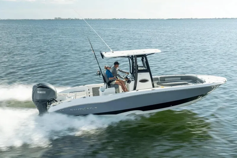 Slide: The Image of 2026 NauticStar 251 Hybrid boat cruising on open water with Yamaha engine. - 2