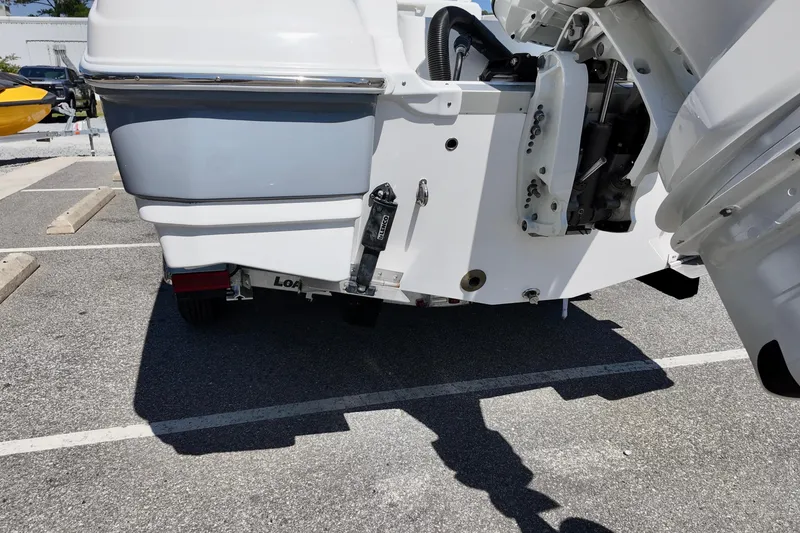 Slide: The Image of 2026 NauticStar 251 Hybrid boat rear view in parking lot. - 22