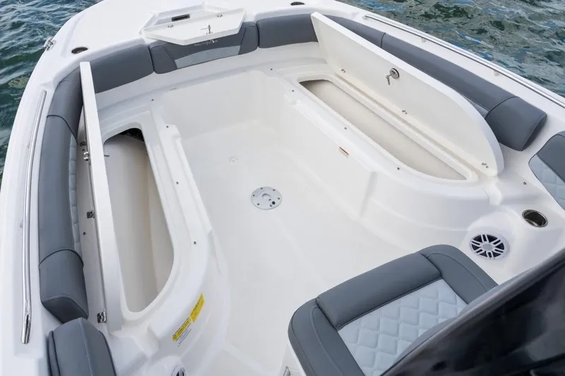 Slide: The Image of 2026 NauticStar 251 Hybrid boat interior with open storage compartments and cushioned seating. - 3