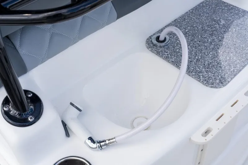 Slide: The Image of 2026 NauticStar 251 Hybrid boat interior with sink and hose detail. - 5
