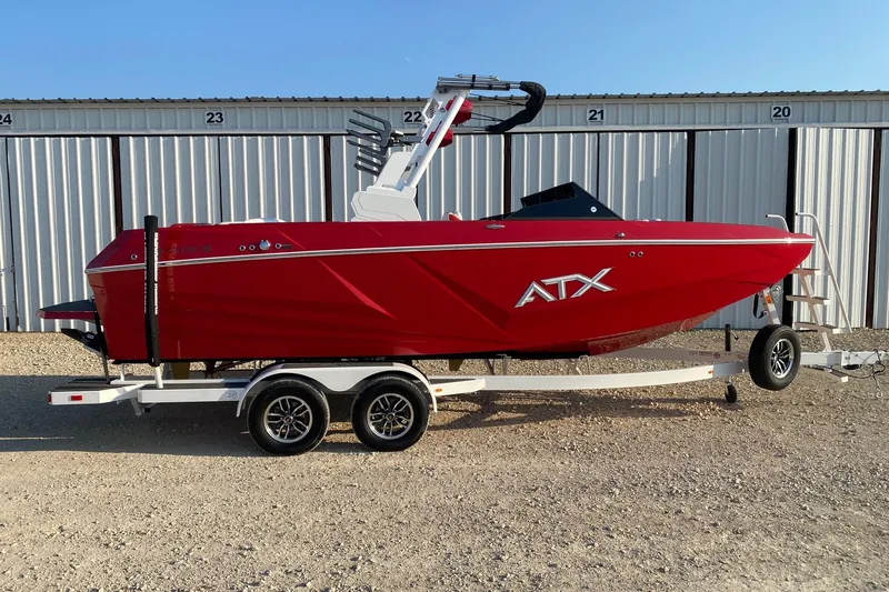 The Image of Red 2026 ATX Surf Boats 22 Type-S on trailer, parked in front of storage units. - 0