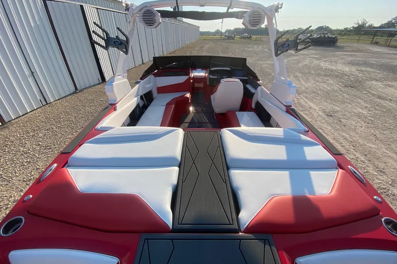 Slide: The Image of 2026 ATX Surf Boats 22 Type-S interior with red and white seating, outdoor setting. - 5