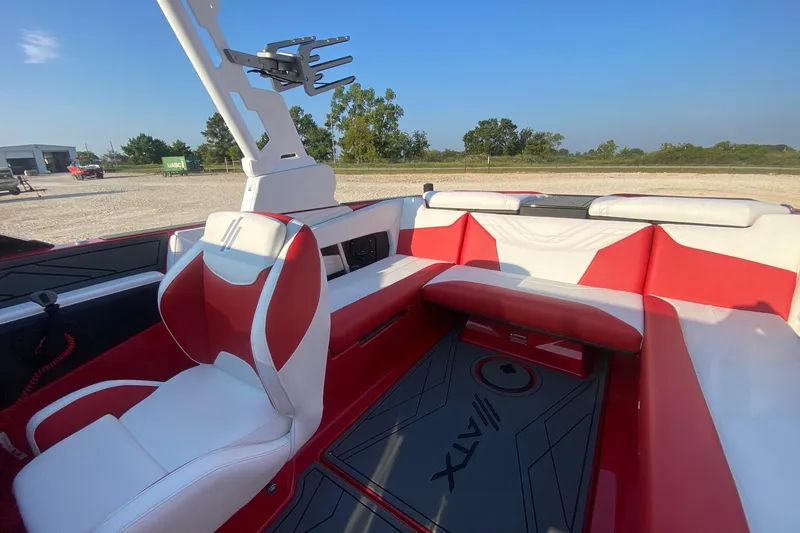 Slide: The Image of 2026 ATX Surf Boats 22 Type-S interior with red and white seating, outdoor setting. - 7