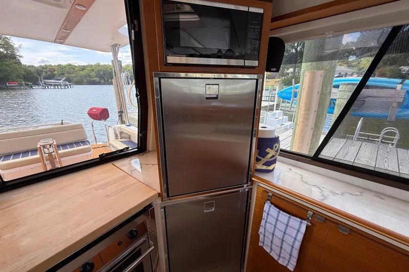 Slide: The Image of Interior of 2021 Ranger Tugs R-41CB yacht with kitchen appliances and scenic water view. - 19