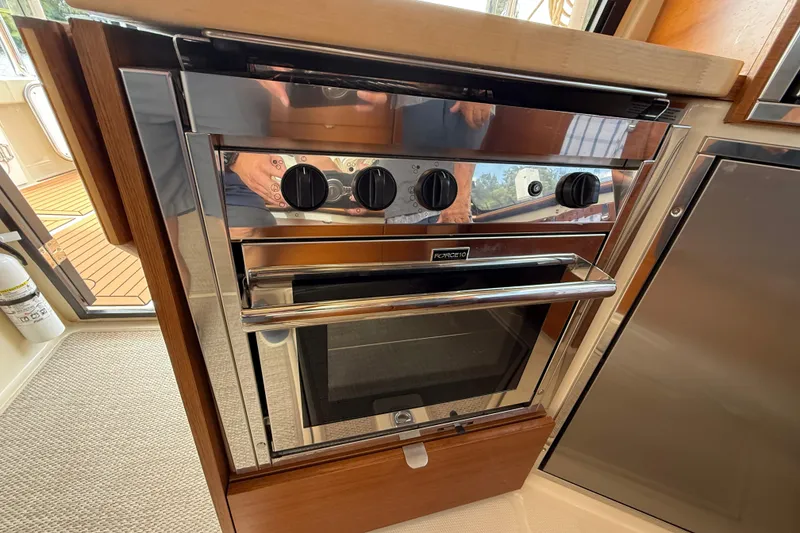 Slide: The Image of Stainless steel oven in 2021 Ranger Tugs R-41CB boat kitchen interior. - 21