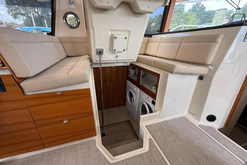 Slide: The Image of Interior of 2021 Ranger Tugs R-41CB with seating and laundry area. - 26